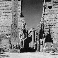 Луксор. Египет. Фронтон I пилона с колоссальными статуями Рамсеса II. С левой стороны обелиск этого же фараона. Фотограф: Анджей Дзевановский